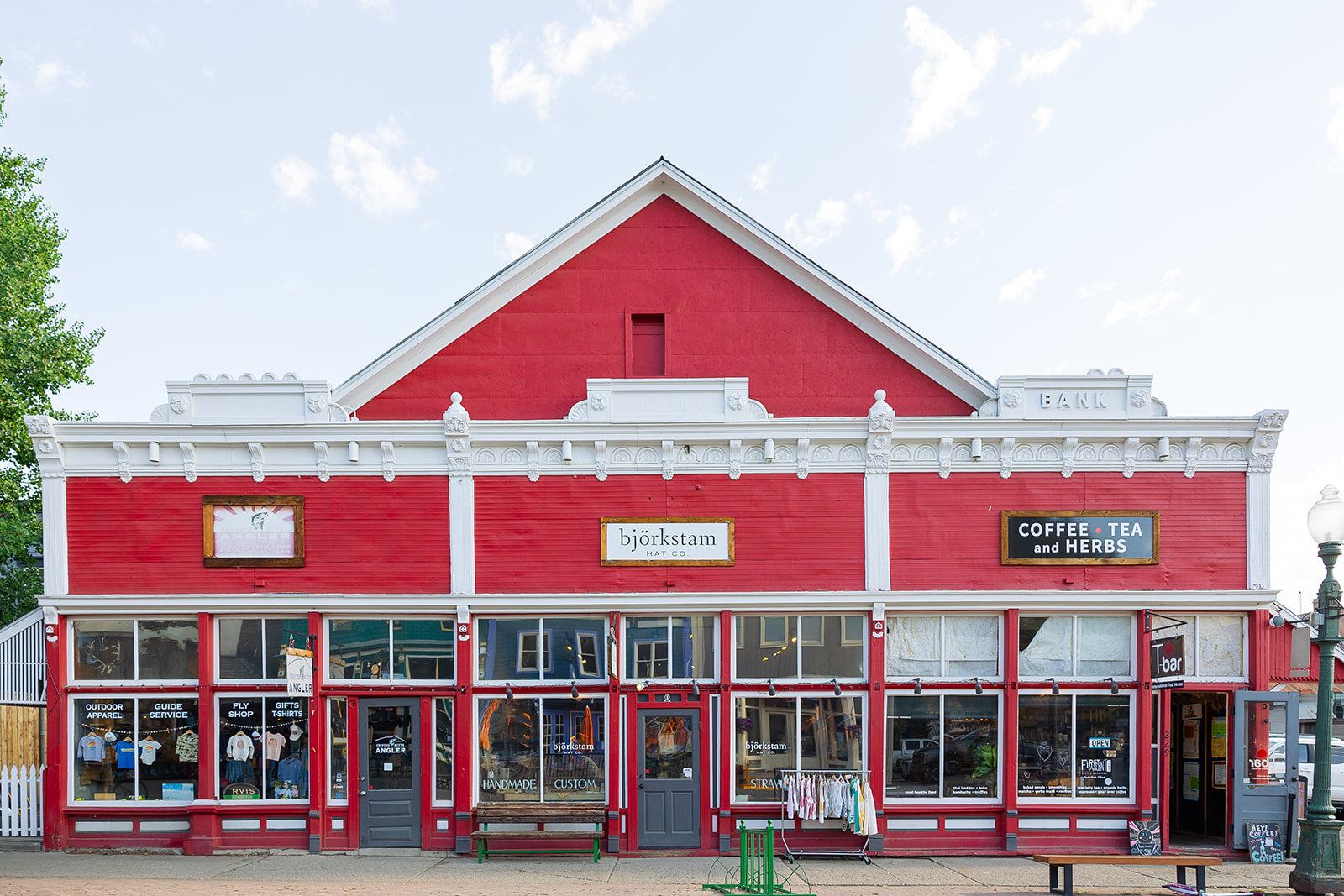 Red building with white trim and a sign on a clear day