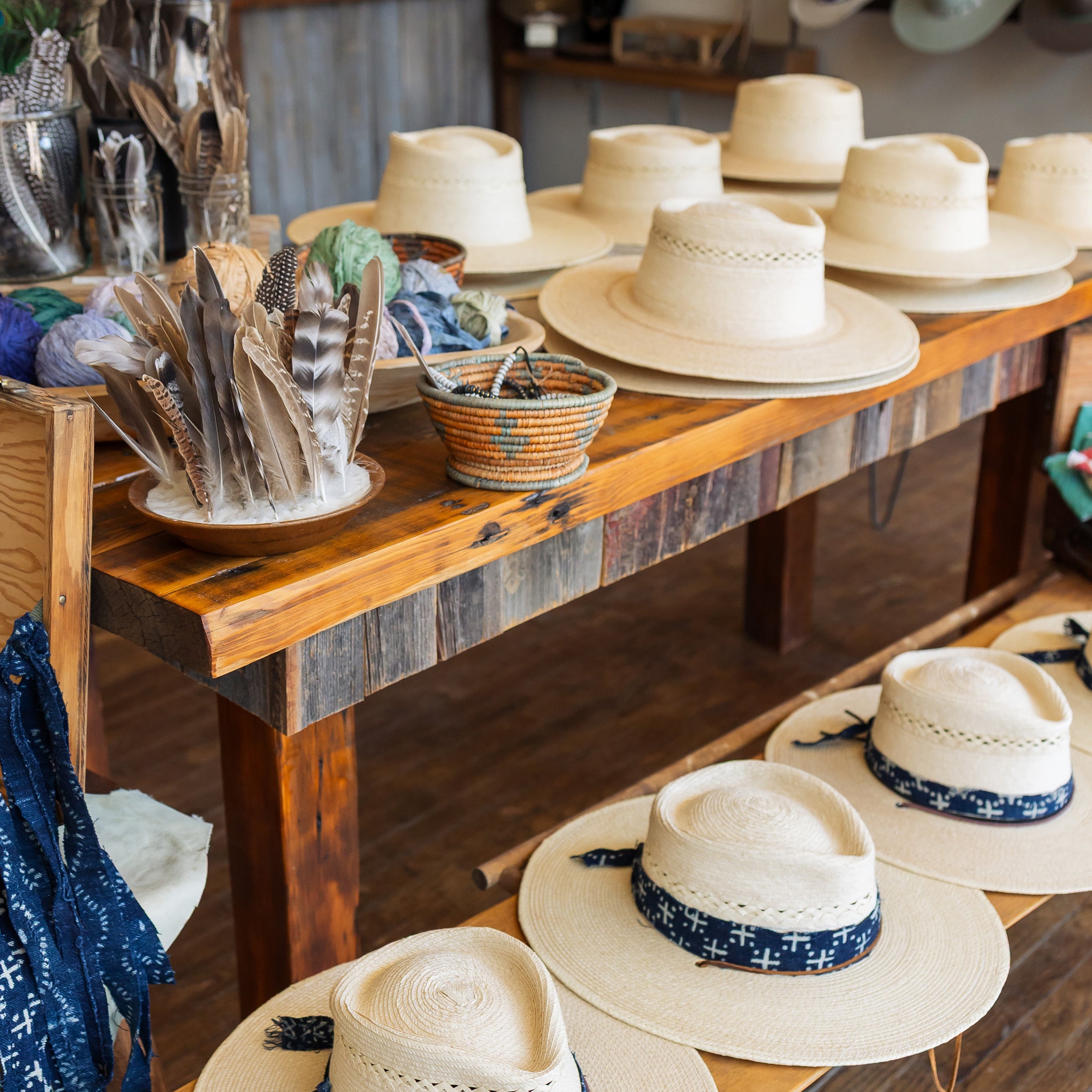 Display of hats on a wooden counter in a store setting