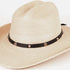 A light beige woven straw fedora hat with a black ribbon band decorated with small metallic studs, shown on a plain white background.