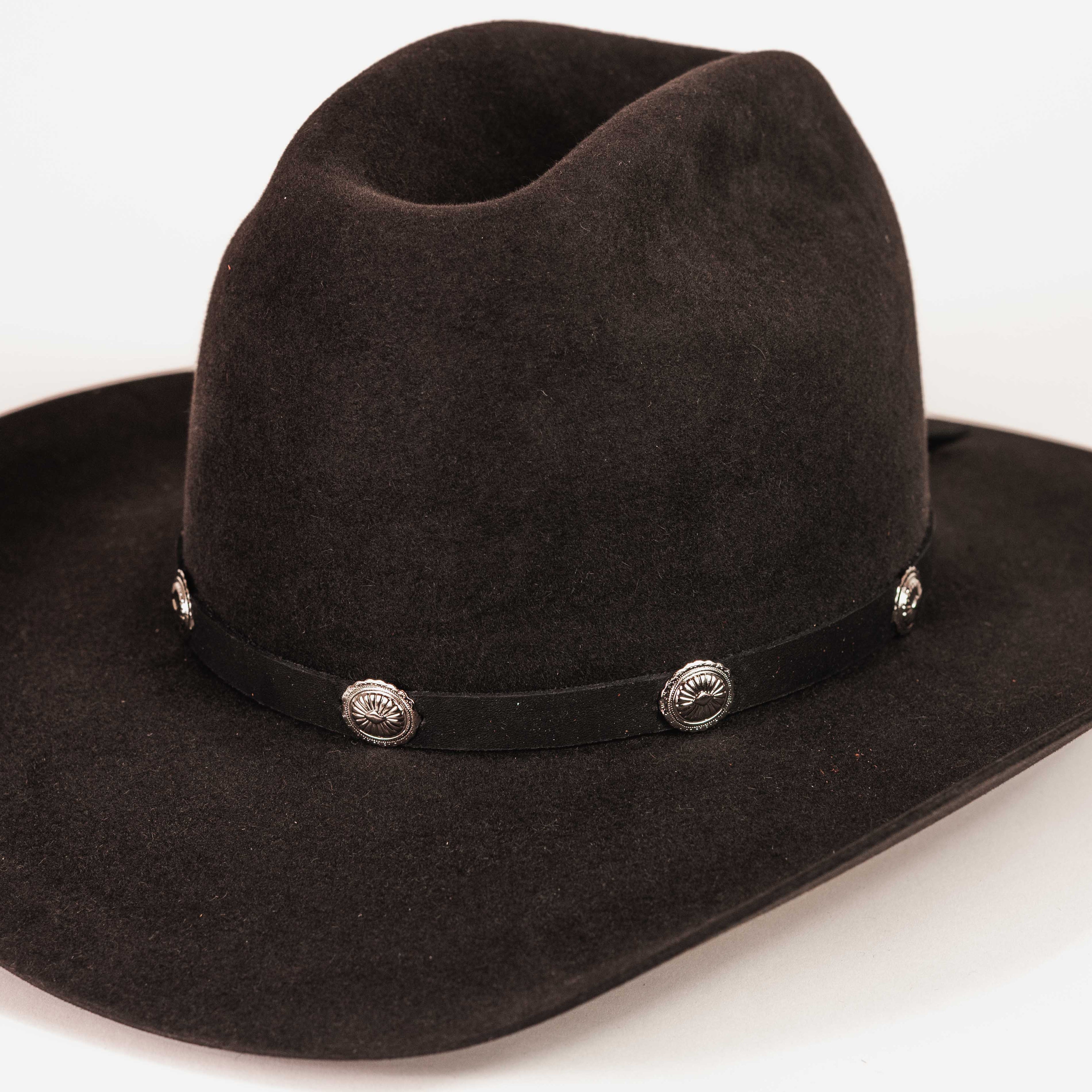 A black felt cowboy hat with a matching black band decorated with silver conchos, shown on a plain white background.