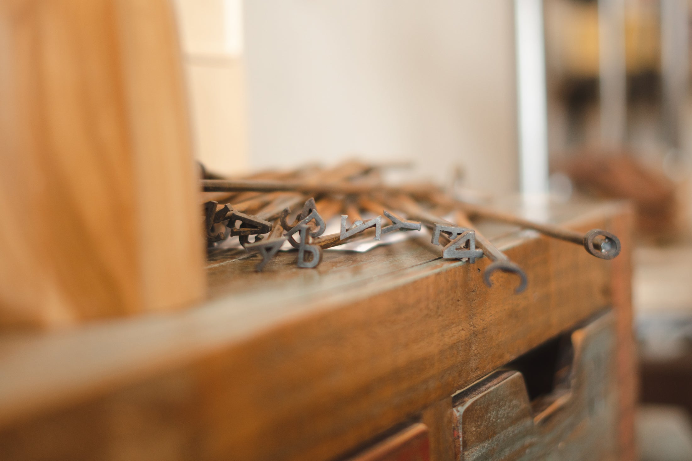 Set of branding letters on a wooden surface with a blurred background