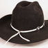 A black felt cowboy hat with a white rope band decorated with silver-toned conchos and a white hanging tie, shown on a plain light background.