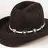 A black felt cowboy hat with a white band decorated with silver conchos, shown on a plain light background.