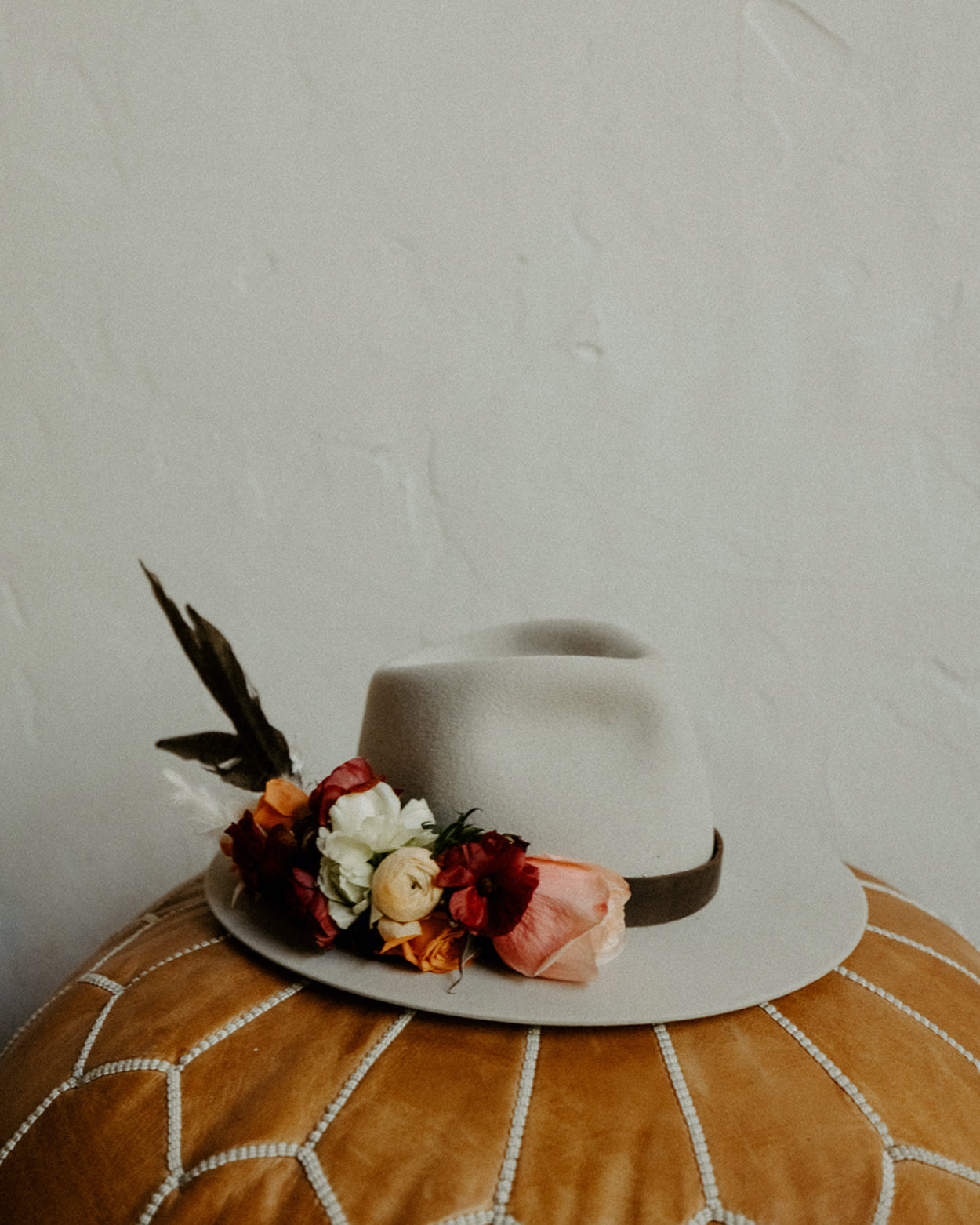 Custom western wedding hat with floral arrangements for the bride.