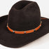 A black felt cowboy hat with a brown leather band decorated with silver conchos, shown on a plain white background.