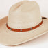 A light beige woven straw cowboy hat with a brown leather band decorated with silver-tone conchos and studs, shown on a clean white background.